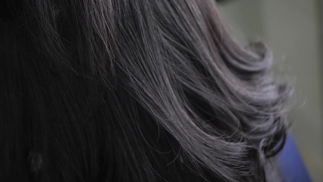 hairdresser using spray setting hairstyle