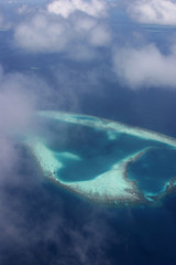 Fototapeta na wymiar Blue and turqouise coral reef and atol, in the Maldives, aerial view, panorama from the air. 
