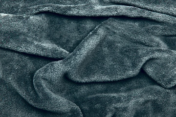 Background and texture. The blurred image of the texture of the fabric for clothing. Gray fur. Cropped shot, isolated, close-up, blurred, horizontal