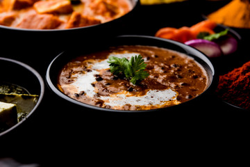 Indian Lunch / Dinner main course food in group includes Paneer Butter Masala, Dal Makhani, Palak Paneer, Roti, Rice etc, Selective focus