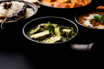 Indian Lunch / Dinner main course food in group includes Paneer Butter Masala, Dal Makhani, Palak Paneer, Roti, Rice etc, Selective focus