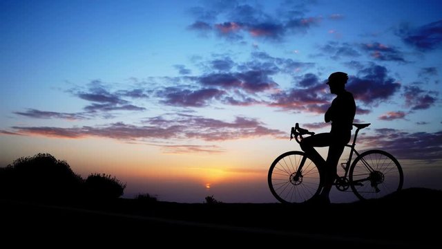 mountain biker silhouette in sunrise