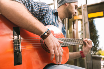 Right chord. Close up of male hands playing on guitar and holding chord