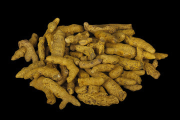 heap of dried turmeric isolated on black background. top view