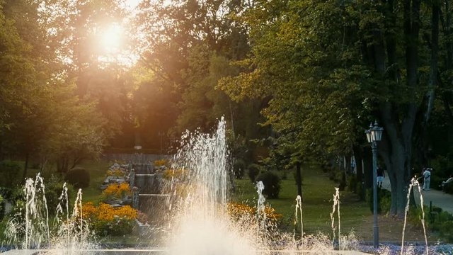 Public park with nice artesian fountain at sunset. Central park - Govora, Romania