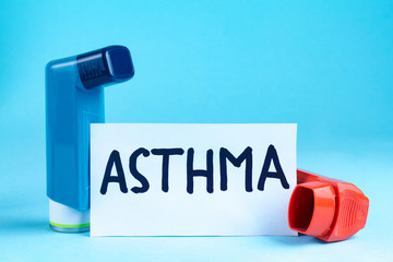 Various asthma inhalers on a blue background. Asthma and copd disease concept