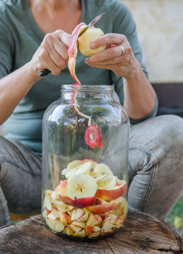Woman Makes Apple Vinegar - Peeling Apple And Cut It Into A Bottle