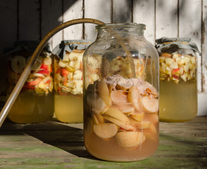 Making of apple vinegar - apple pieces floating on water in a glass