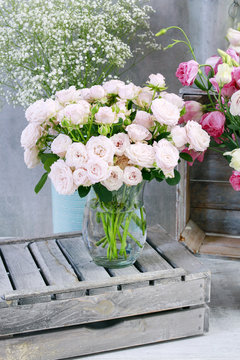 Bouquet of pink roses and other plants in flower shop.
