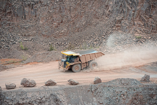 dumper truck driving around in a porphyry mine quarry.
