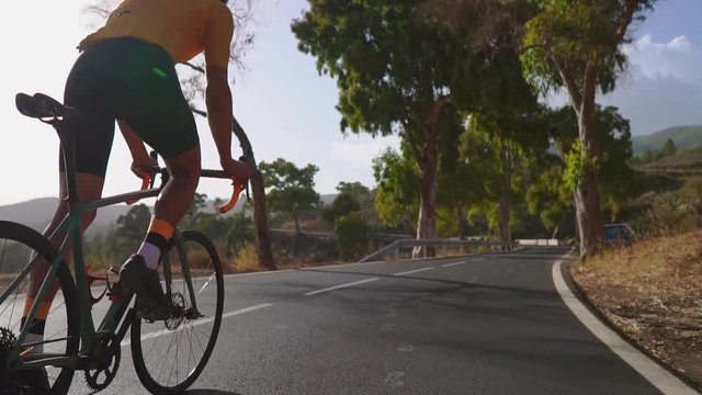 Man cycling on road bike outdoor exercise on an empty road in the morning .Extreme sport concept. Slow motion