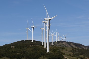 LANDSCAPE WITH MOUNTAINS AND  WIND TURBINES GENERATING ELECTRICITY