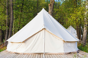 Canvas glamping tent at forest