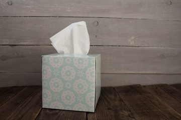 a box with napkins on wooden background