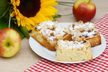 apple cake, sunflower  and apples on table