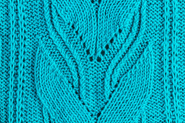 The texture of a turquoise knitted yarn. Knitted and winter clothes