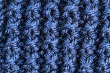 The texture of a blue knitted yarn. Knitted and winter clothes