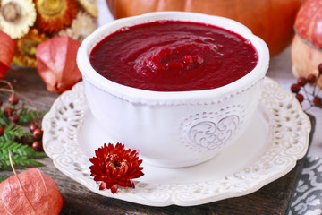 Creamy autumn soup in white plate.