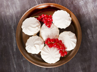 Fresh red currants and a white marshmallows