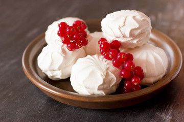 Fresh red currants and a white marshmallows