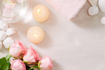 Spa settings with roses. Spa theme with candles and flowers on table.