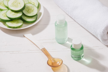 Obraz na płótnie Canvas Cosmetic bottle and fresh organic cucumber for skincare. Home spa concept.