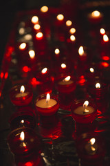 Candles with red holders in a church in Brussels Belgium