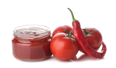 Red sauce in a jar and fresh ingredients, tomatoes, peppers on a white isolated background. Tomato sauce. Ketchup