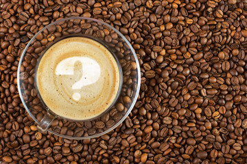 Cup of espresso with question mark on coffee foam on coffee beans background. With copy space