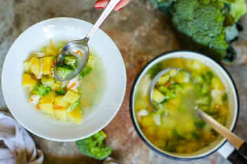 soup with broccoli, chicken and vegetables (on the table) on gray background. . top view. food background
