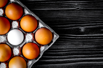 concept of correct choice eggs on wooden background top view