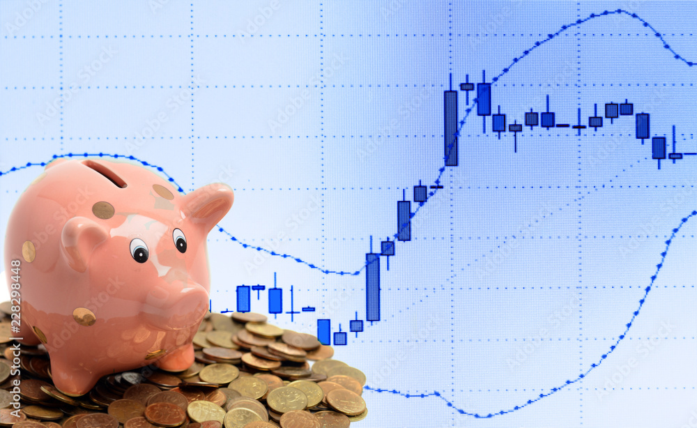 Wall mural coin piggy bank and business candle graph chart of stock market investment trading on computer scree