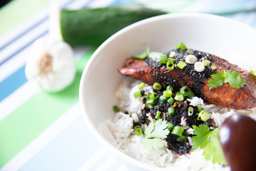 Salmon Teriyaki on a white bowl and stripes background