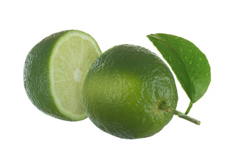 two halves of green lime with green leaves isolated