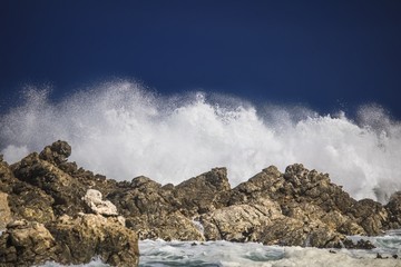 Dramatic big stormy crashing waves splash. Kleinmond, Western Cape, South Africa.