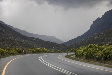 Road path through mountain range on Clarence Drive, Kleinmond, Western Cape, South Africa.