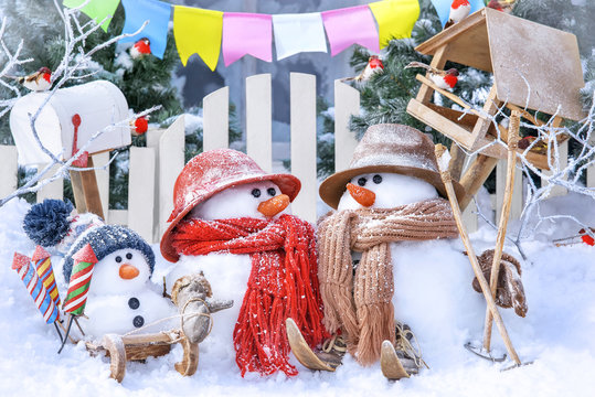 Postcard with Christmas and a new year with three cute snowmen