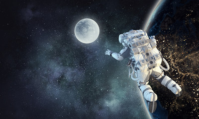 Obraz na płótnie Canvas Astronaut on space mission. Mixed media