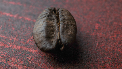 Naklejka premium coffee grain macro photo. on red stand