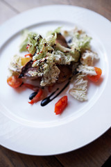 dish beef salad pepper tomatoes sauce fork on wooden table
