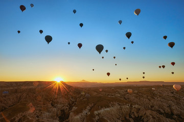 Hot air balloons in the sky during sunrise in Cappadocia, Turkey