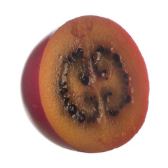 half of tamarillo isolated on white background
