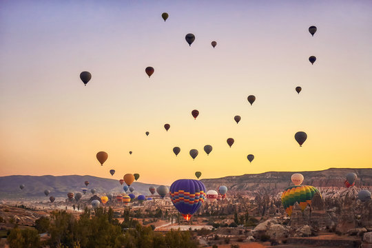 Hot air balloons taking off early in the morning at Goreme, Cappadocia.