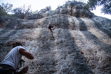 Man checking climber on mountain 