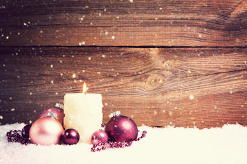 candle in snow christmas background