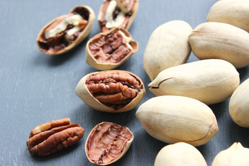 Pecan nuts on a wooden table close-up. Healthy food, healthy lifestyle, diet, vegetarianism.