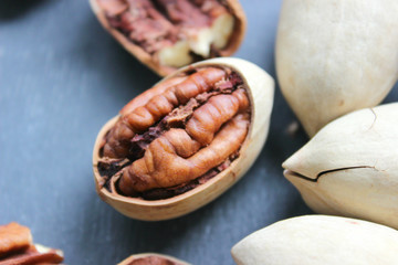 Pecan nuts on a wooden table close-up. Healthy food, healthy lifestyle, diet, vegetarianism.