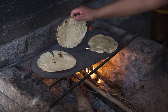 Antonio 11 years old in the kitchen with his mother preparing tacos, San Juan del Fresno, Manuel Doblado, province of Guanajuato, Mexico