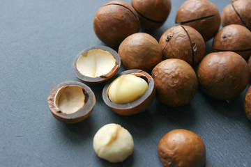 Macadamia nuts on a wooden table close-up. Healthy food, healthy lifestyle, diet, vegetarianism.