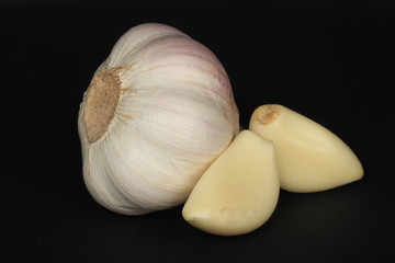 heap of garlic isolated on black background